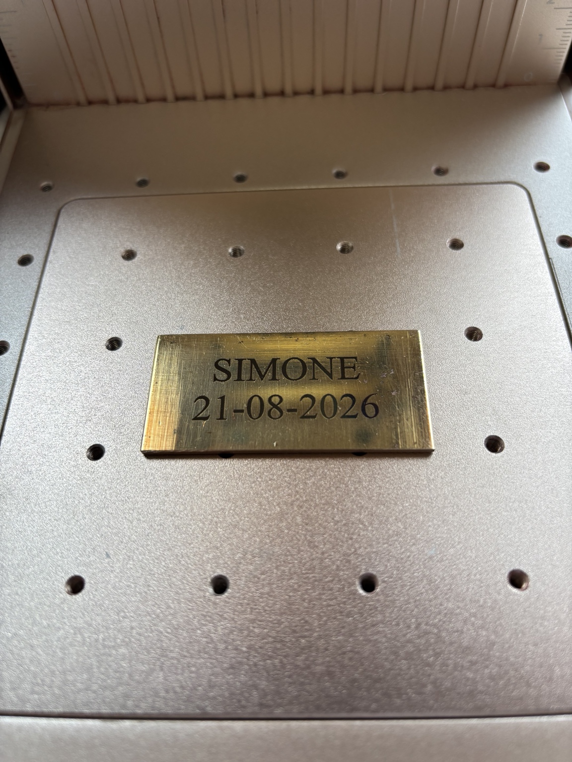 Personalised name and date engraved onto a brass memorial plate