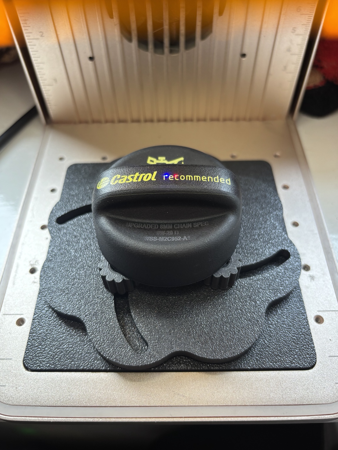 Full view of a customer oil cap with custom laser-marked specifications