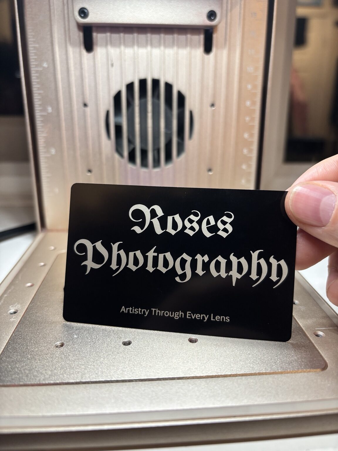 Roses Photography branding engraved onto a black aluminium business card