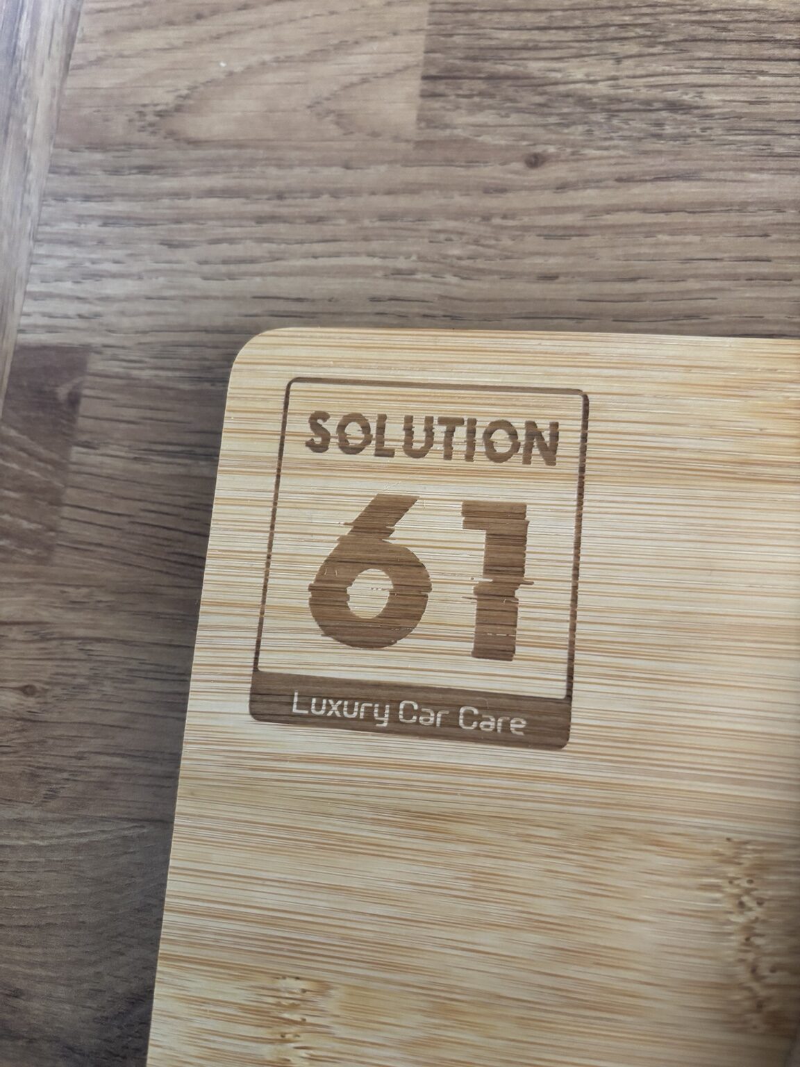 Solutions 61 logo engraved onto a bamboo board